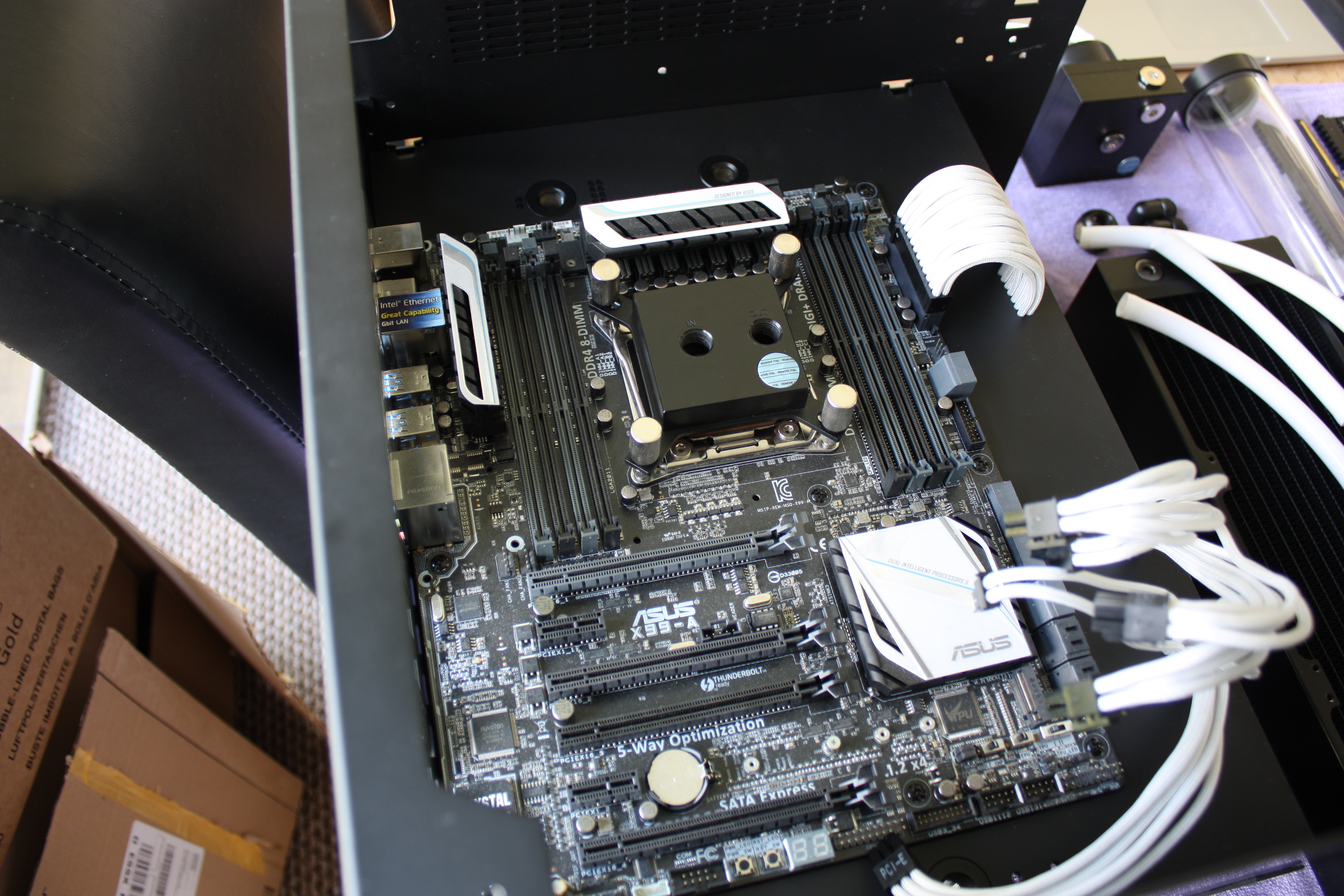 Installation of CPU waterblock and motherboard.